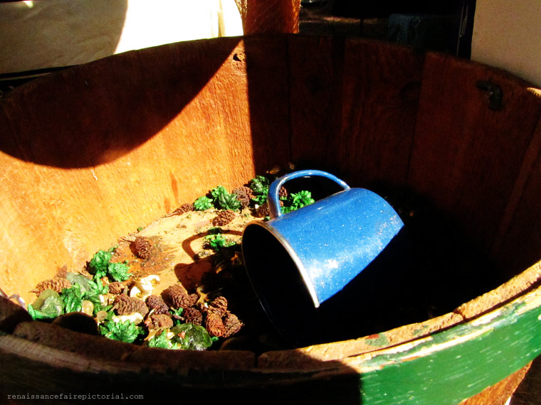 blue mug in a basket  with potpourri.