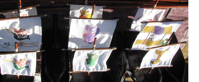 lady in blue hat red beaded necklace.