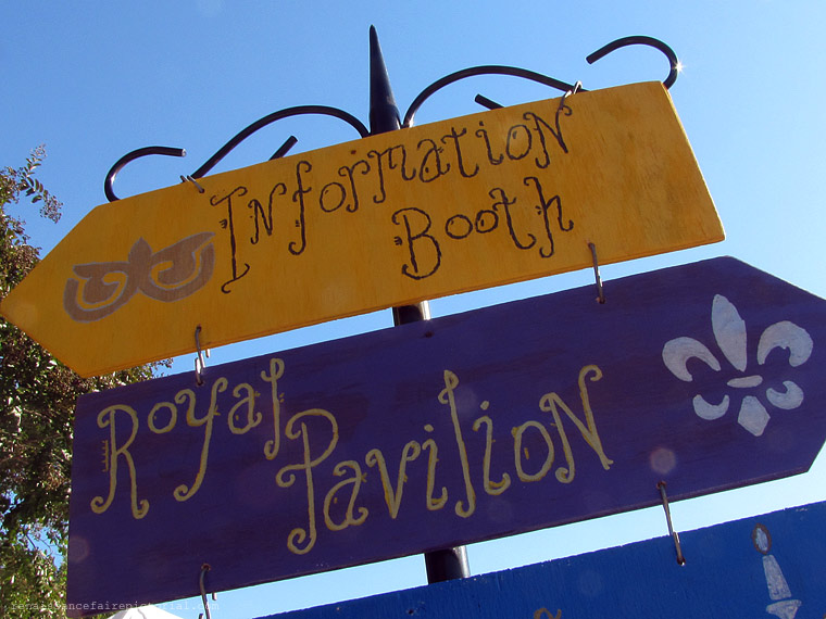 hand painted signs one say information booth the other says royal pavilion.
