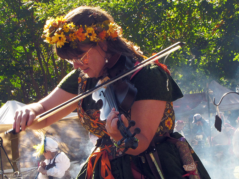 fiddle player with smoke behind her.
