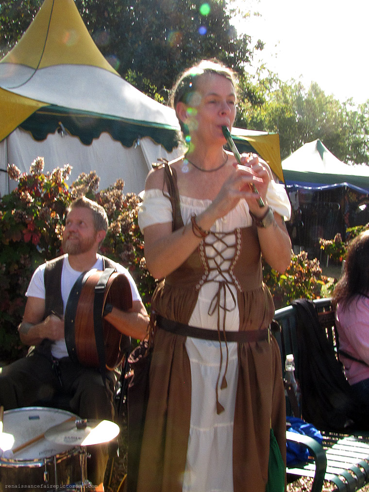 woman playing flute, man drumming