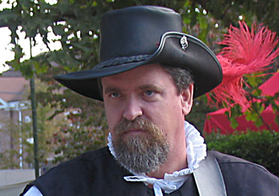 man in black hat black vests