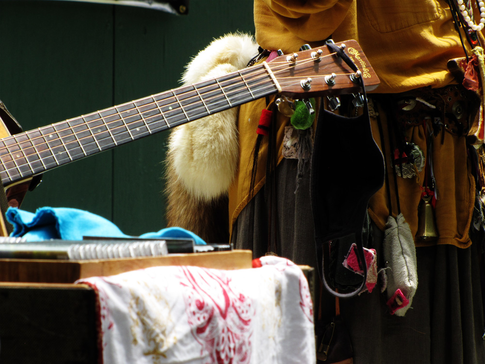 guitar with a mask dangling off the end.