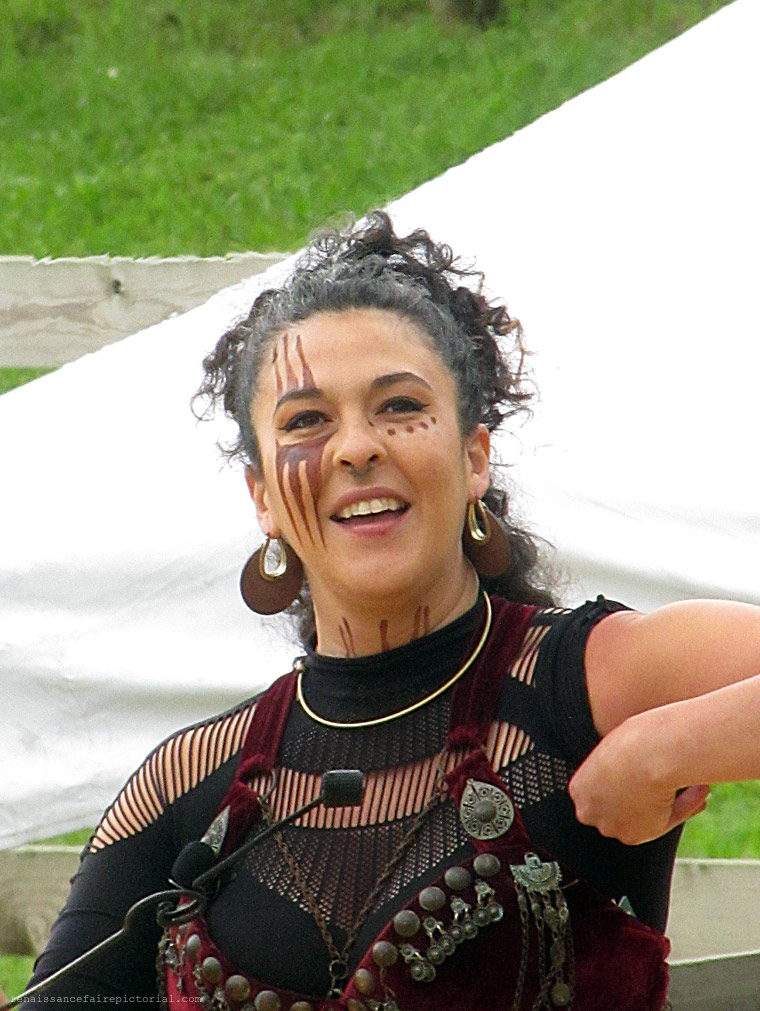 woman with dark hair and tribal makeup.