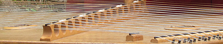 close up of  Hammer dulcimrer, it's wood with string like a piano or harp.