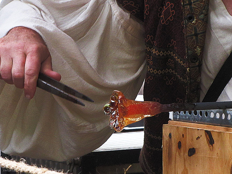glassblower makinga a glass flower.