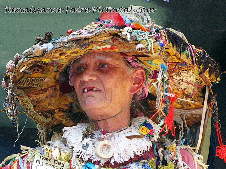 wman in large hat it is covered in ribbions and trinkets.