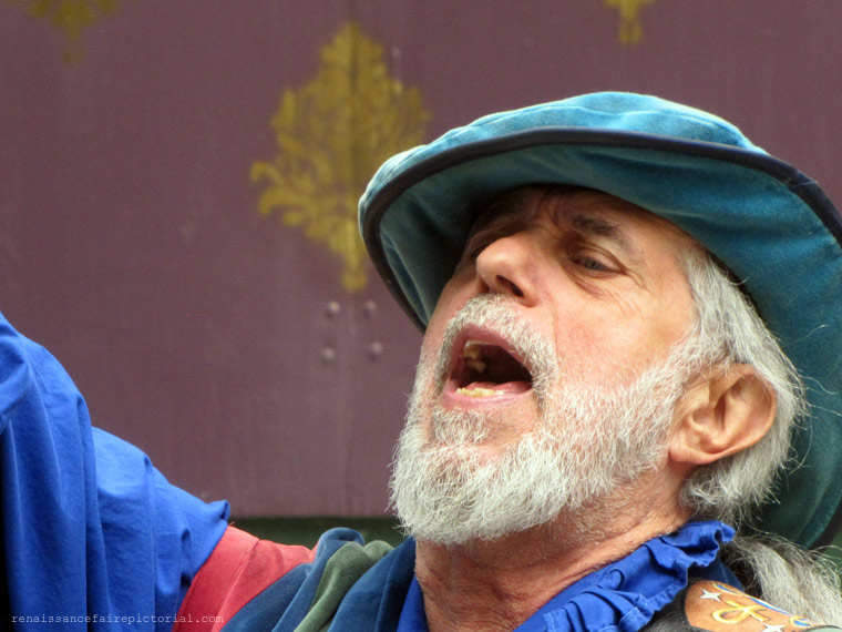 Man in blue shirt singing.