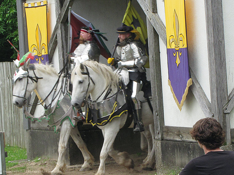 2 knights on horseback entering the tournament field.