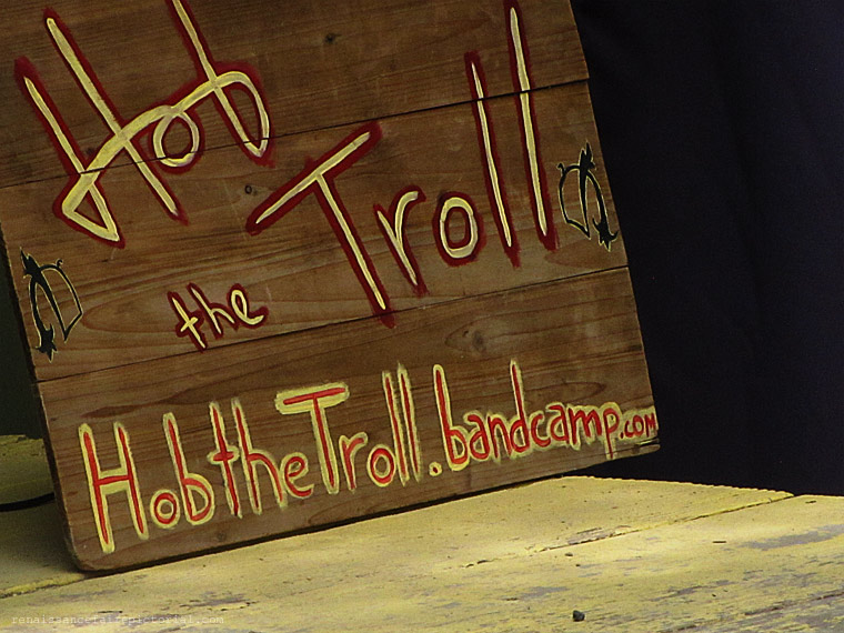 wood sign reads Hpb the troll hobthetroll.bandcamp.com 