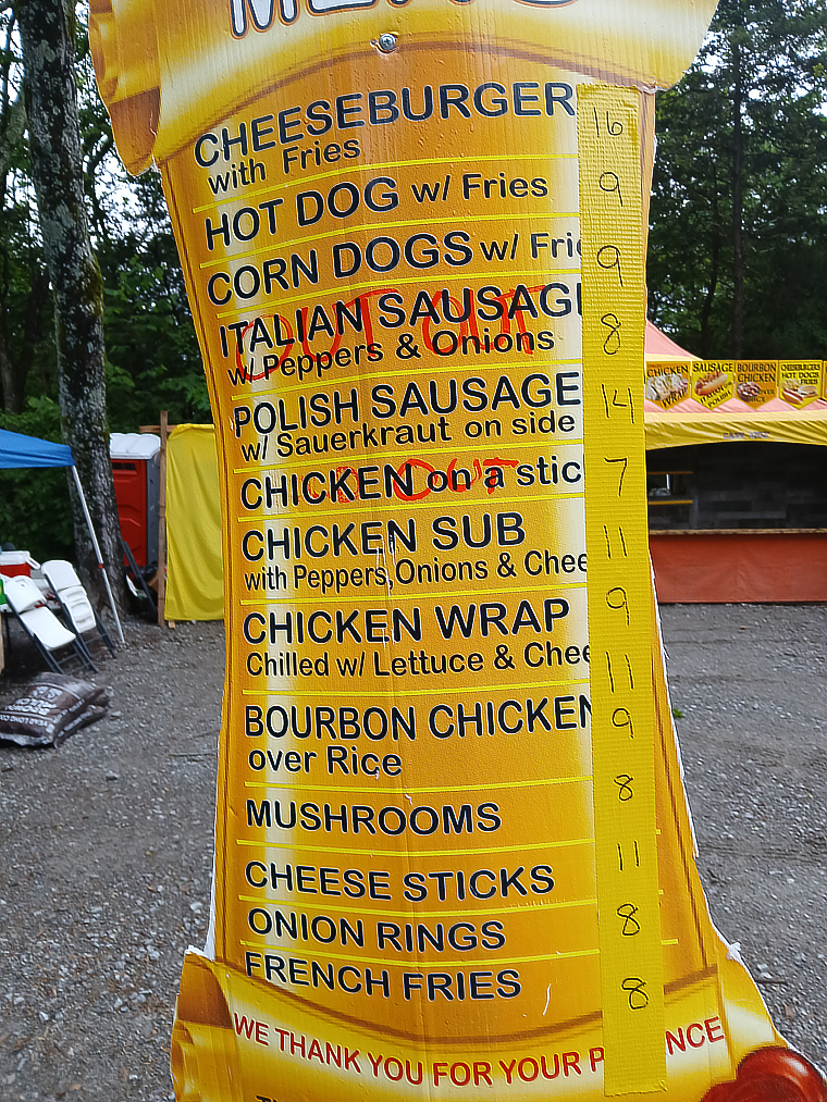 a menu board made to look like a scroll.