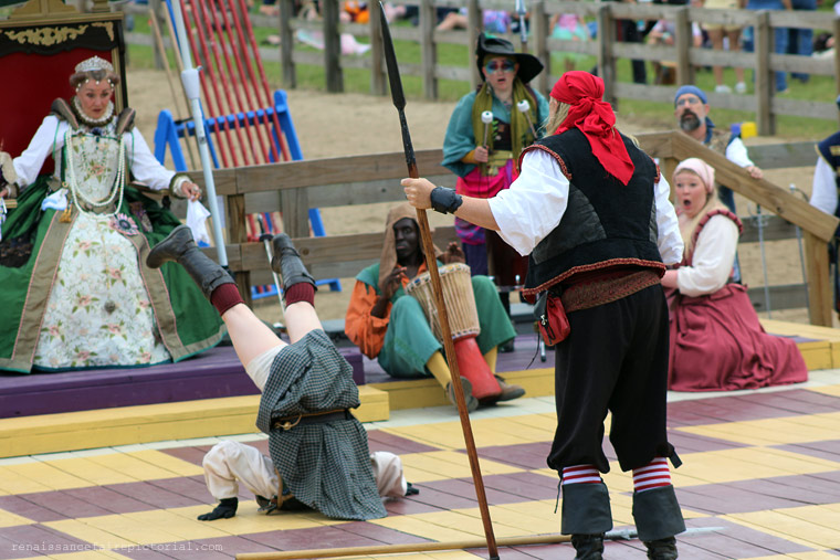 human chess. young actor in kilt taking a tumble. crowd is shocked.
