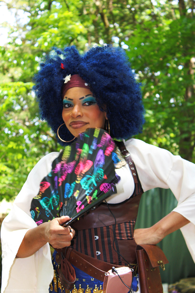 Dark skinned lady piarte with blue hair